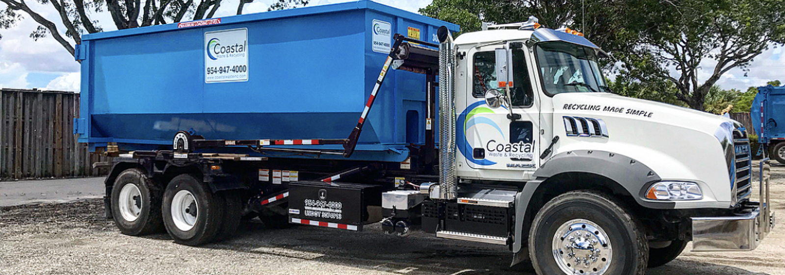 Dumpster loaded on truck in Coastal Waste's Yard in West Palm Beach, FL